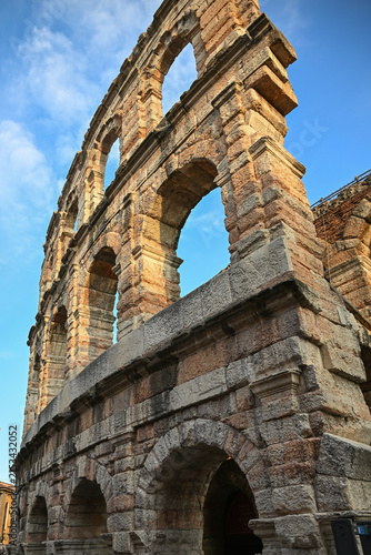 Ancient Roman Arena di Verona arches illuminated by evening sunlight