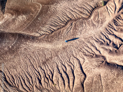 Fotografie Aerial Abstract Texture of Desert Erosion Patterns and Geological Layers
