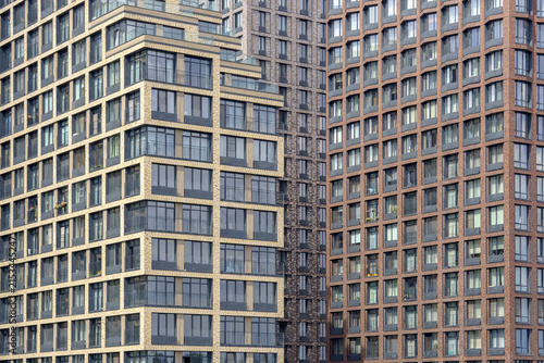 Terraced residential skyscraper facades forming a dense geometric angle. Multi-level apartment buildings structure for modern urban housing backdrop.