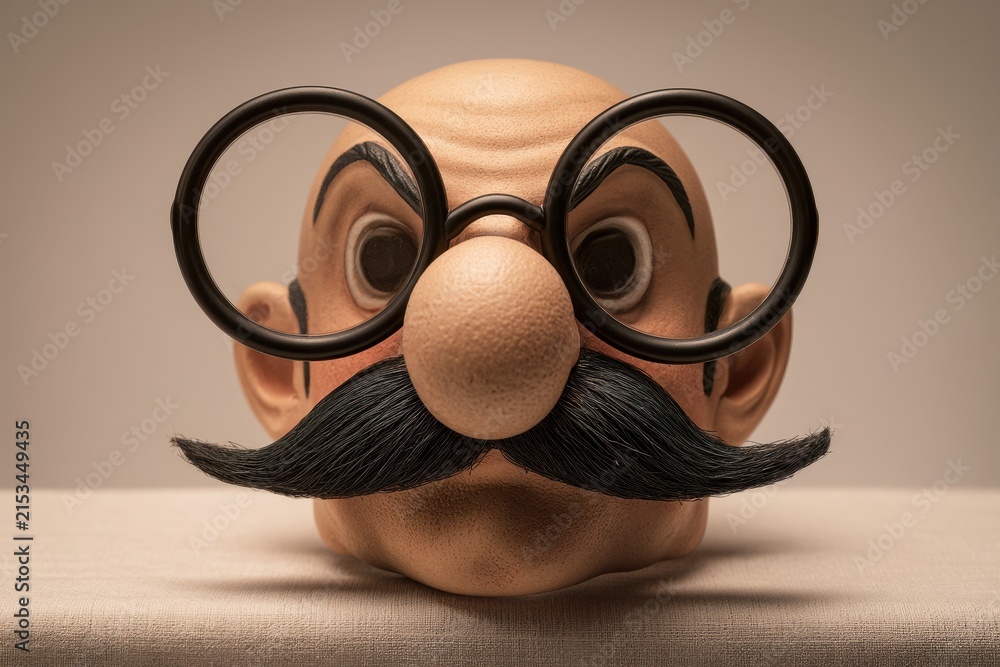 Fototapeta premium Vintage-inspired prop mask featuring quirky eyewear and exaggerated nose for entertainment visuals