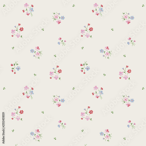 Delicate floral pattern with pink and blue blossoms on a cream background