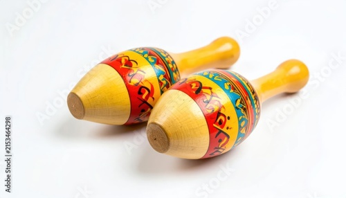 Two traditional wooden maracas with colorful patterns on white.