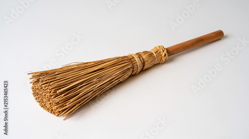 Traditional thatcher single straw bundle isolated against sterile white background sabbatical return career reflection planning single object heritage craft tool minimal composition artisan roof tha