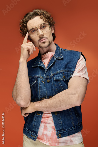 Canvastavla Handsome man showcases emotional pose in stylish denim vest and trendy outfit
