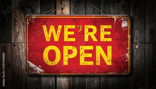 Weathered Red Open Sign With Bold Yellow Letters Mounted On A Dark Weathered Wooden Wall Exterior