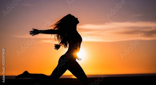 Silhouette of Free Woman Leaping with Arms Spread at Golden Sunset