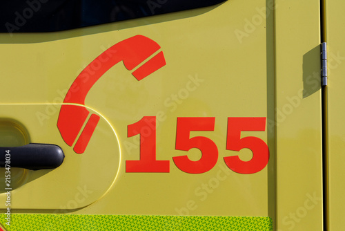 Ambulance emergency vehicle in the Czech Republic and Czechia. Detail of yellow car with bright reflective colors and 155 telephone number. 