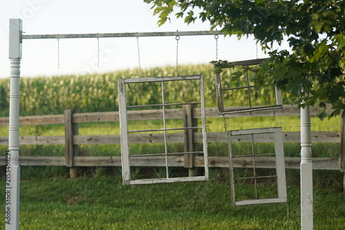 random rustic window frame art in front of a corn field.