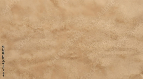 Close-up of a textured beige wall surface showcasing natural variations and subtle color gradients for interior design or