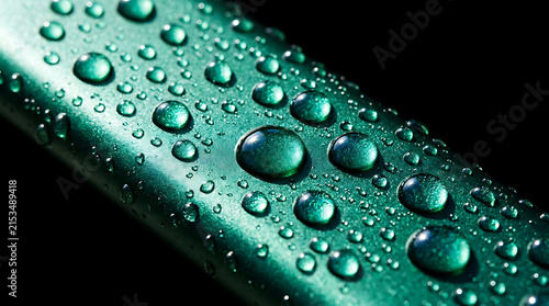 Water droplets on glossy green leaf surface, macro view