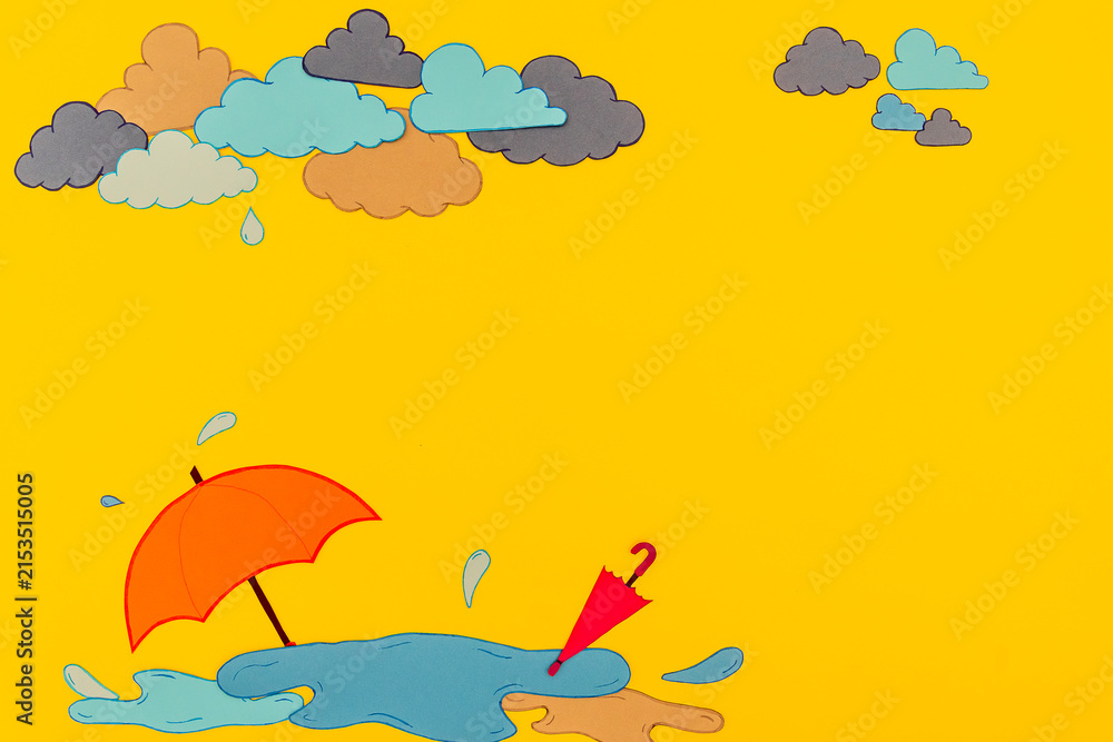 Fototapeta premium Bright yellow background features an orange umbrella on a puddle with clouds above