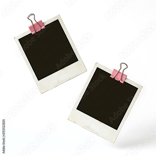 Two blank vintage polaroid photo frames with pink binder clips isolated on white background