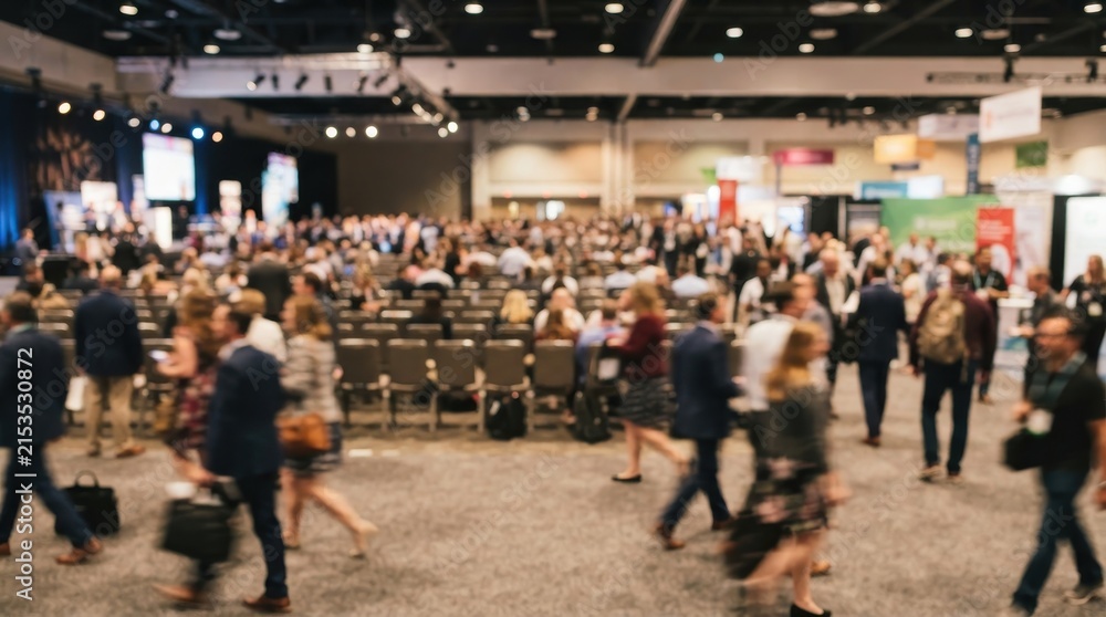 Fototapeta premium Blurred crowd of professional people walking in a large conference hall