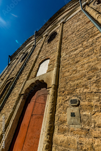 Red door and a brown door on a brick building, Svishtov, Bulgaria, Saint Trinity church, sea level mark