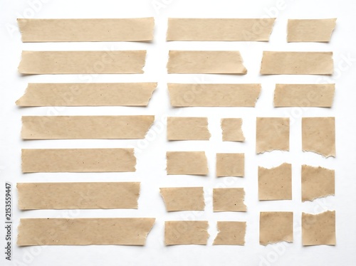Fotografie Collection of torn brown packing tape strips on white background.