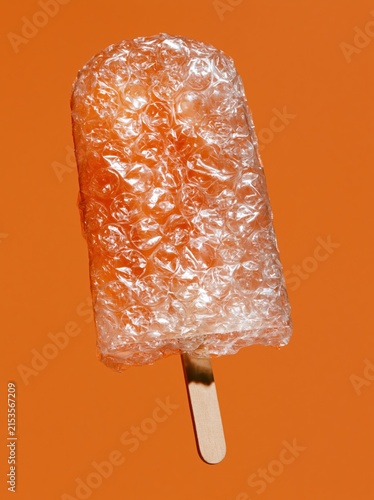 Bubble Wrap Ice Pop with Large Transparent Bubbles on Vivid Orange Background