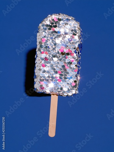 Silver Sequin Ice Pop with Strong Cast Shadow on Royal Blue Background