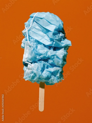 Blue Surgical Mask Ice Pop with Crumpled Mask Texture on Warm Orange Background