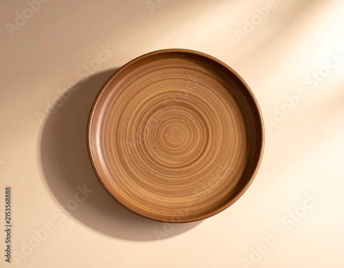 Elegant Brown Ceramic Saucer with Smooth Glazed Surface and Minimal Tableware Design on Soft Beige Background