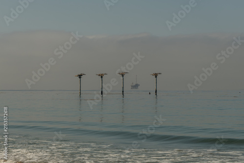 Scenic vista of old piling relics off the Pacific coast in Goleta, Santa Barbara County, Southern California 
