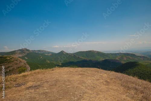 Expansive mountain range landscape under clear sky