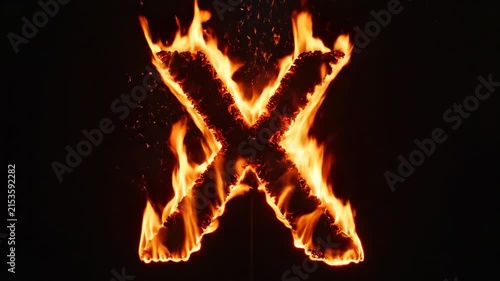 A large letter X engulfed in bright orange flames and smoke against a solid black background.