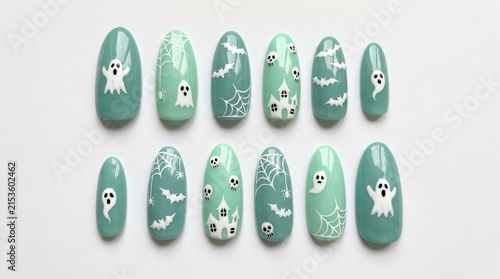 Set of pastel mint green Halloween press-on nails with cute white ghost, bat, haunted house and spiderweb art isolated on white background