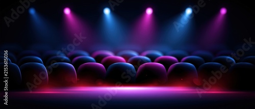 Empty stage with colored spotlights and glowing light effects over a dark auditorium seating area for event backdrop or conference banner.