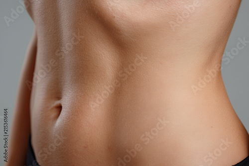 Slim waist abdomen belly navel skin fold torso smooth skin female body midriff close up