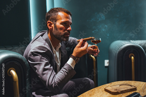 Konstfotografi Businessman Relaxing in Luxury Lounge Smoking Cigar and Sipping Cognac After Wor