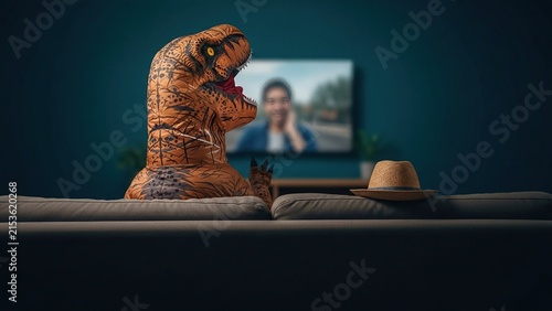 Person in Dinosaur Costume Relaxing on Sofa Watching Television