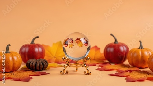 Autumn Crystal Ball Composition with Pumpkins and Fallen Leaves