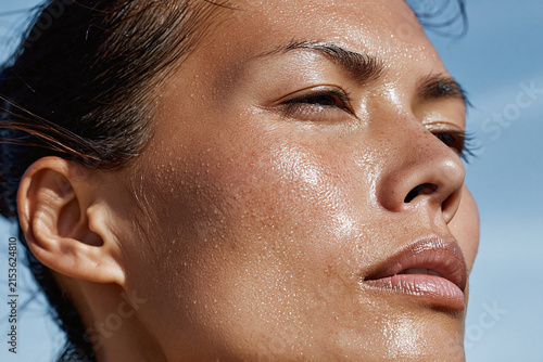 Serene close up runner soft sweat droplets on skin glowing athletic woman outdoors sunlit