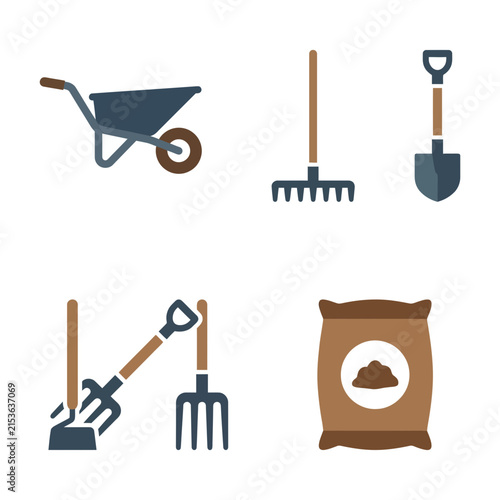 Wheelbarrow and garden tools collection featuring shovel rake and fertilizer bag for agricultural use.