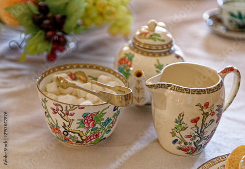 Close Up of Vintage Floral Porcelain Sugar Bowl and Creamer Pitcher