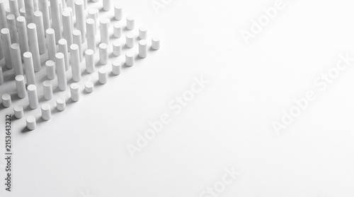 Abstract Cylindrical Array: A minimalist abstract composition featuring a precise array of white cylindrical rods arranged in a geometric pattern, suggesting order and structure.