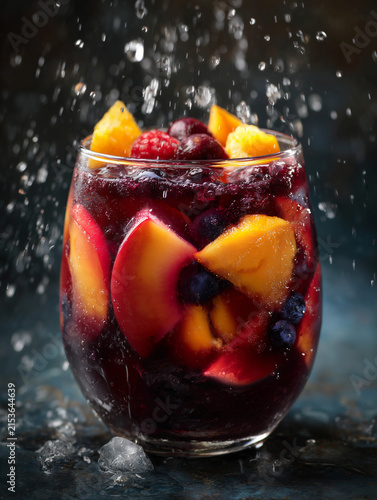 Refreshing red sangria cocktail splashing with summer fruit