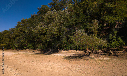 Принти на полотні Dry and shallow riverbed with exposed rocks and stones during prolonged summer drought