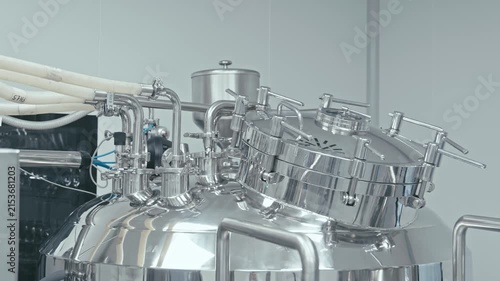 Production facility, shining metal machinery is hard at work. Pipes, valves, and gauges. Technology and automation. Factory machine at work. 4K, UHD
