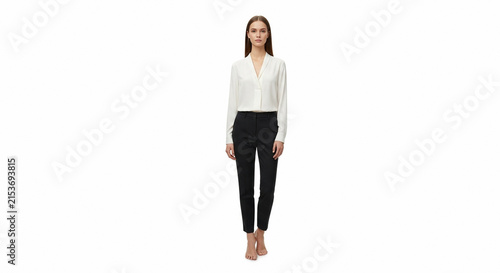 Woman in white blouse and black pants standing
