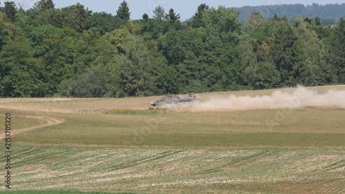 Recovery tank vehicle of Swiss Army passing at military training grounds at city of Bülach on a hot and dry summer afternoon. Video shot August 11th, 2026, Zurich Oberglatt, Switzerland.