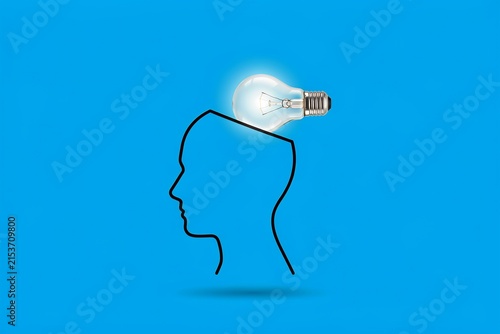 Minimalist outline of a human head with a glowing light bulb representing a bright new idea