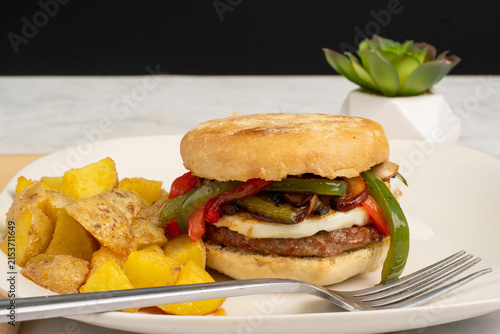 Canvastavla fried egg and  sausage   breakfast sandwich with home fries