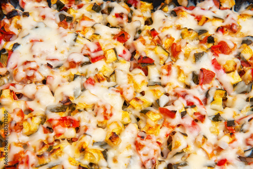 Closeup of Baked Vegetable Casserole made with Zucchini, Sweet Potato, Sweet Bell Red Pepper, Chicken, Cheese and Tomatoes.