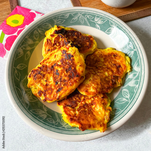 Homemade Vegetarian Fried Vegetable Flour Pancakes with Cabbage in Plate on White Table.