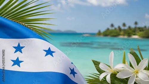 Honduras national flag waving on a tropical beach paradise