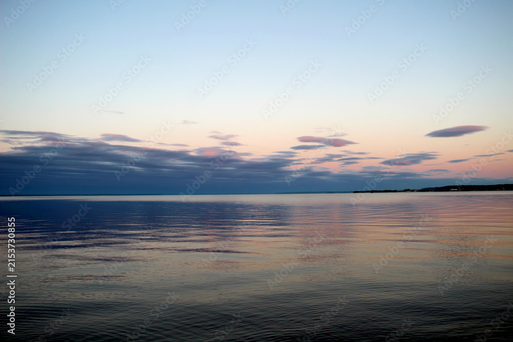 Fototapeta premium Beautiful sunset over a wide river in summer.