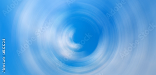 Konstfotografi Abstract blue sky with white clouds spinning in a radial blur vortex circle patt
