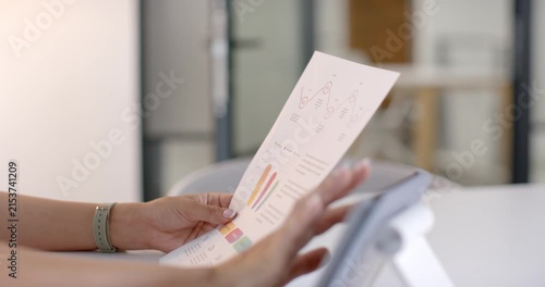 Hands with mint band are lifting and aligning report for inspection to tablet for chart comparison
