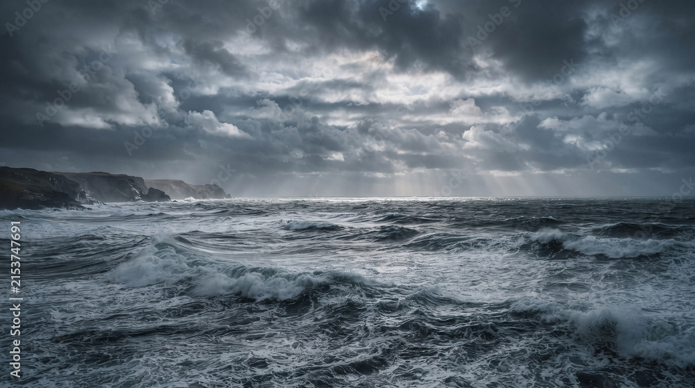Fototapeta premium Dramatic Storm Clouds and Windy Waves Over a Rugged Ocean Coastline